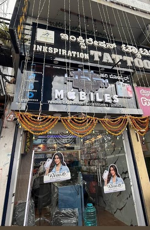 Hari Mobiles shop sign listing mobile services, earphones and chargers